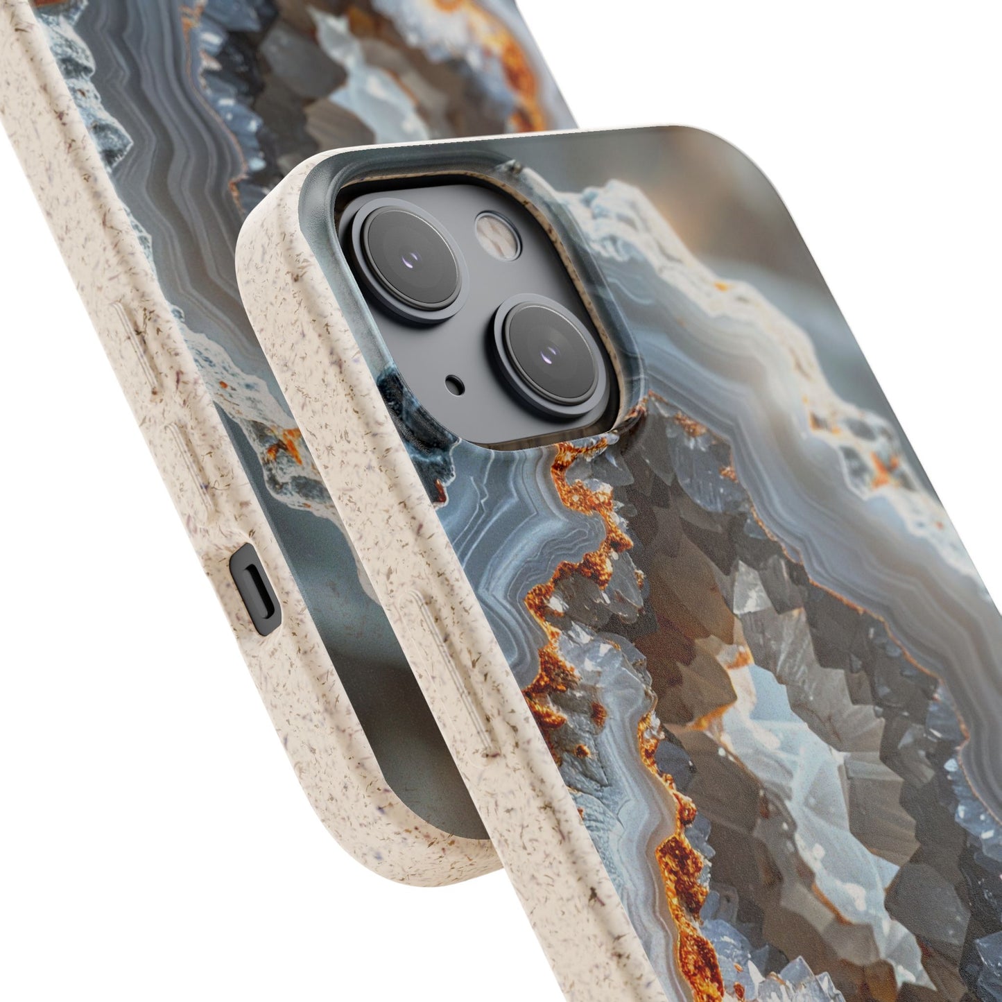 A close-up of a smartphone case with a geode or agate-style pattern in gray, blue, white, and rust-orange tones, plus a speckled beige bumper edge. No person, animal, or real environment is present, so this is Product/Packaging.