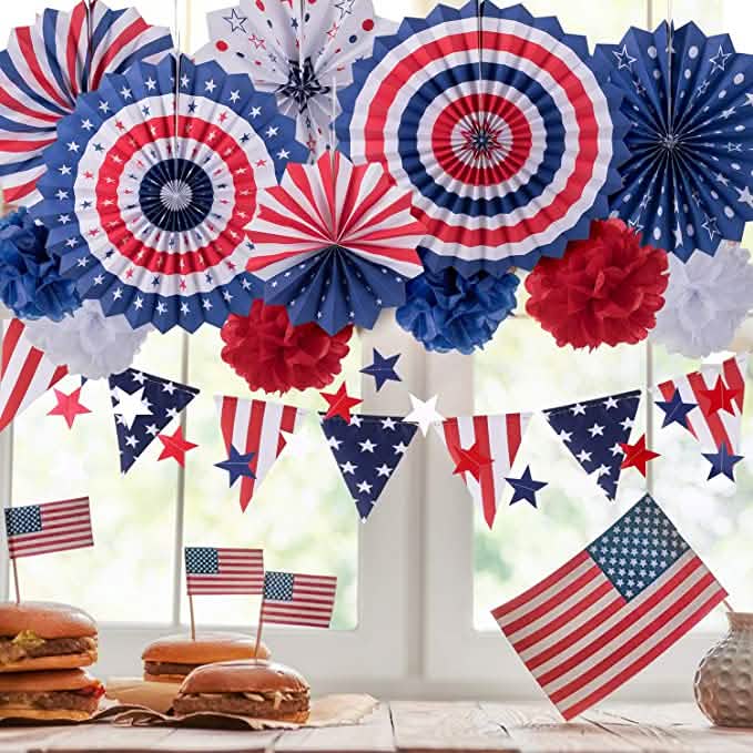 Decorative set with paper fans and American flags on a table.