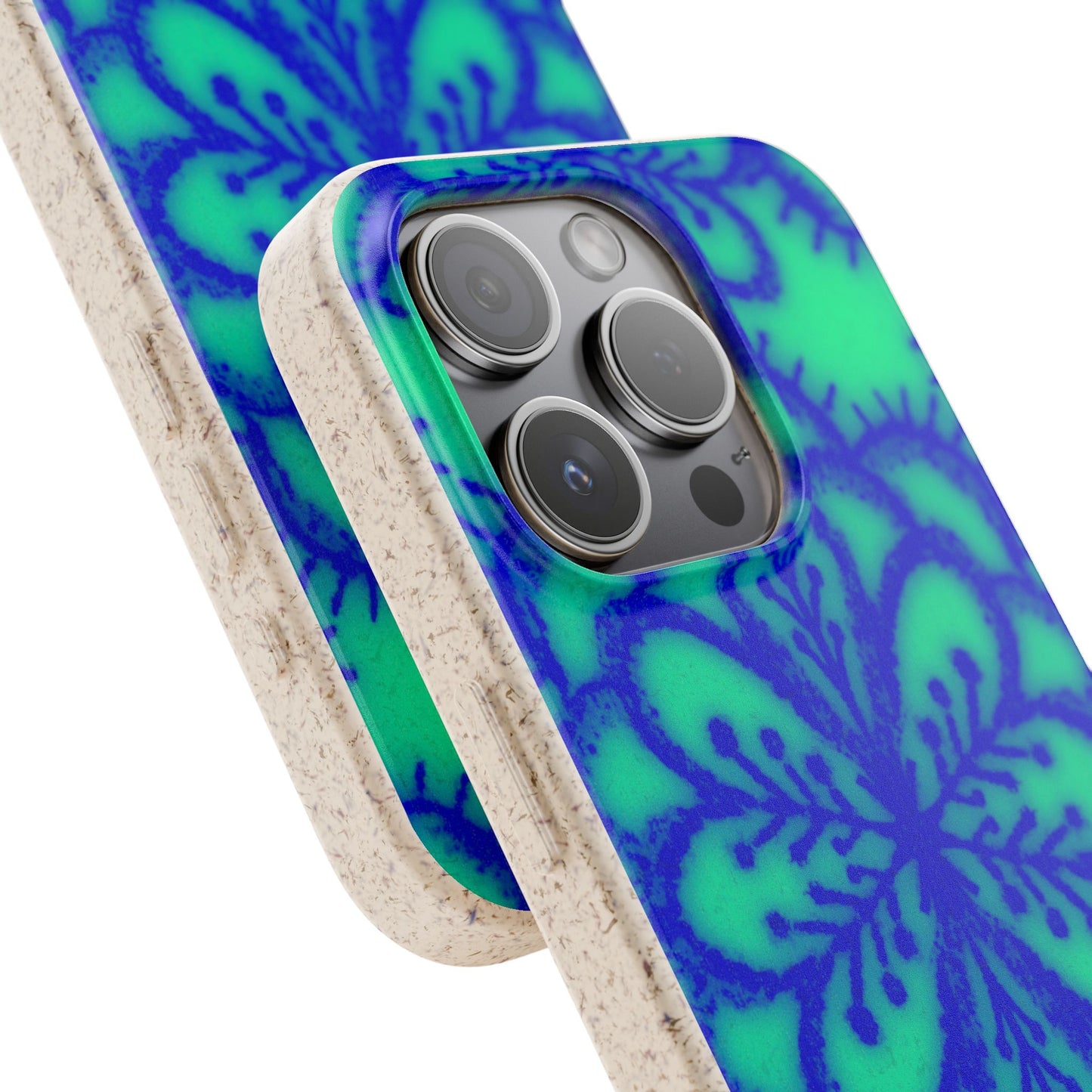 A close-up of a phone case with a vibrant blue and green floral mandala pattern and a natural beige textured cork backing, shown fitted on a smartphone.
