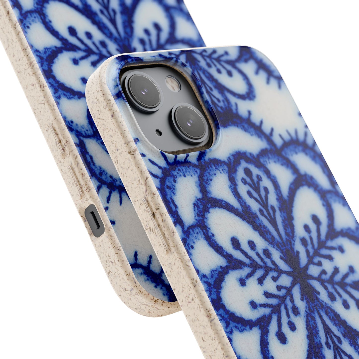 A close-up of a smartphone case with a blue floral mandala pattern on a white background, featuring a natural beige textured cork border.