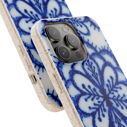 A close-up of a smartphone case with a blue floral mandala pattern on a white background and a textured beige bumper edge, shown fitted on a phone against a clean white background.