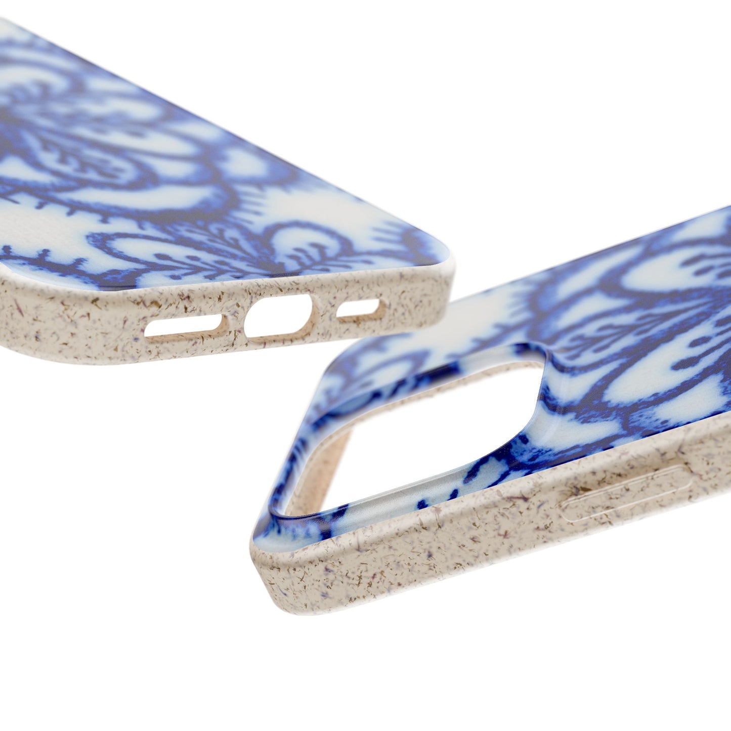 Two smartphone cases with a blue floral pattern on a textured beige background, shown on a clean white studio background.
