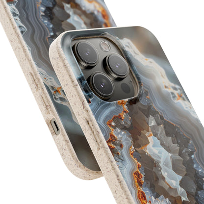 A close-up of a smartphone case with a geode-inspired agate pattern in gray, blue, white, and rust-orange tones, with a speckled beige bumper edge. The phone camera module is visible through a cutout in the back of the case.