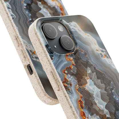 Close-up of a smartphone case with a geode or agate-inspired pattern in gray, blue, white, and rust-orange tones, with a speckled beige bumper edge. No person, animal, or real environment is present.