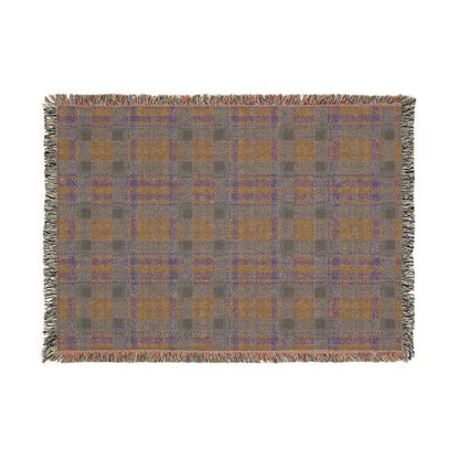 A rectangular woven throw blanket with a plaid pattern in gray, ochre, and blue, featuring fringed edges on all sides, shown against a plain white background.