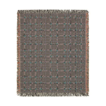 Reverse side of a square woven throw blanket with a textured gray and brown plaid pattern, accented with teal and orange threads, finished with fringed edges.