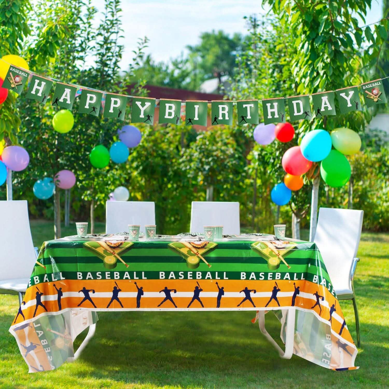 Outdoor birthday party setup with a tablecloth, balloons, and 'Happy Birthday' banner.