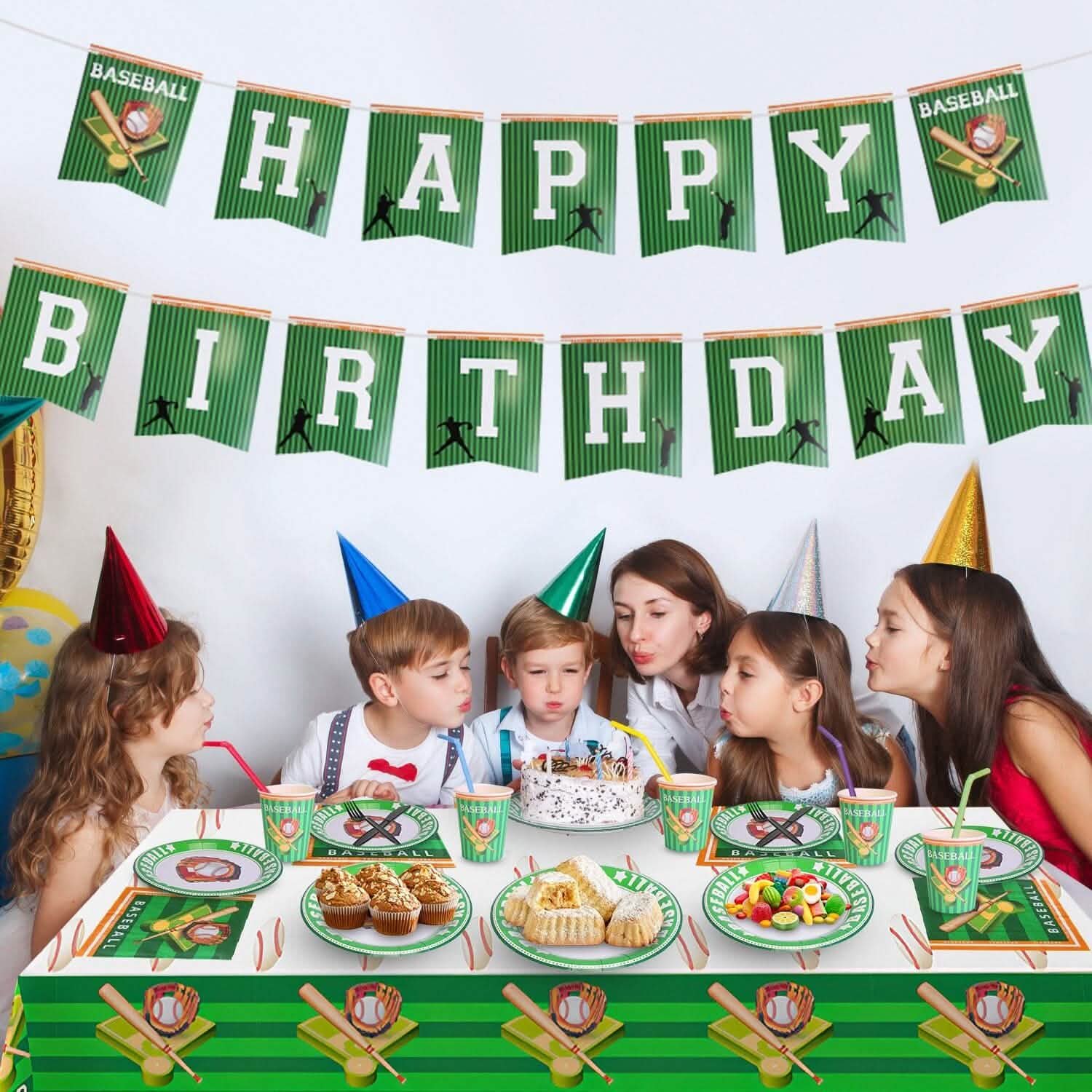 Children and adults at a birthday party with a 'Happy Birthday' banner and sports-themed table setting.