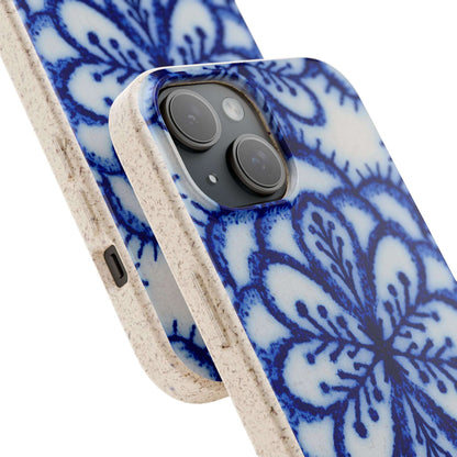 A close-up of a smartphone case with a blue floral mandala pattern on a white background, featuring a textured beige side bumper and a black camera cutout.