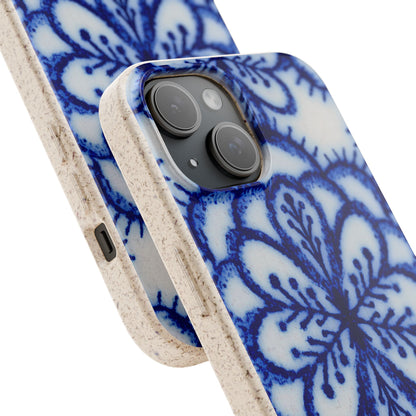 A close-up of a smartphone case with a blue floral mandala pattern on a white background, featuring a textured beige side bumper and a black camera cutout.