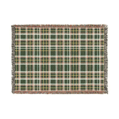 A rectangular woven throw blanket with a green, white, and yellow plaid pattern and fringed edges, shown flat against a white background.