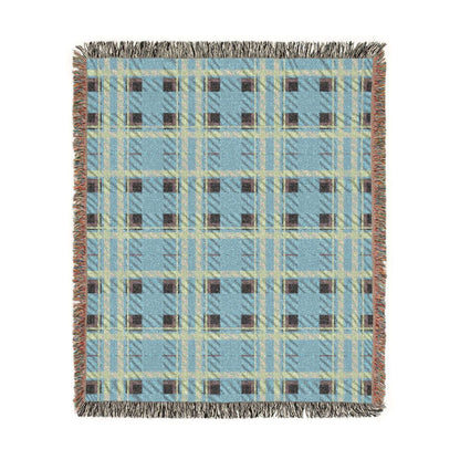 A rectangular woven throw blanket with a light blue, beige, and brown plaid pattern and fringed edges, shown flat against a white background.
