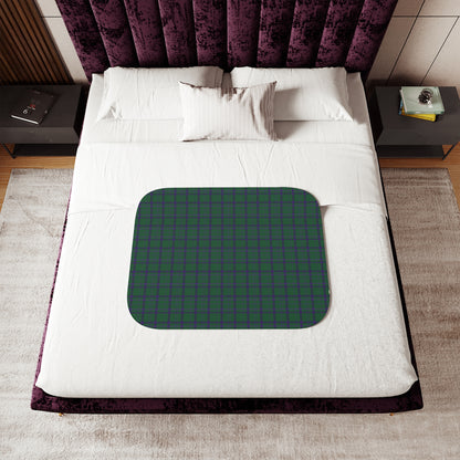 Bed with a green mat featuring text on a white bedspread
