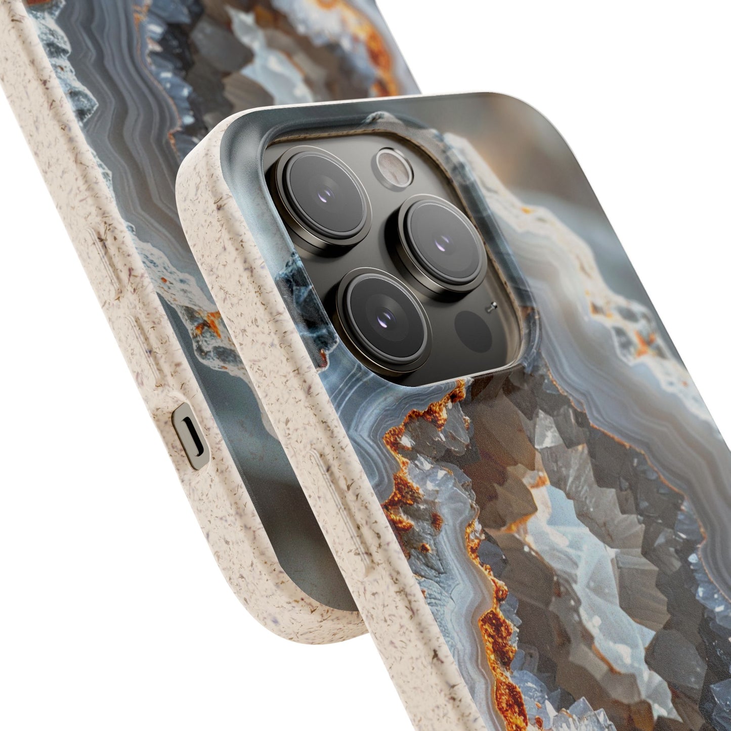 Close-up of a smartphone case with a geode or agate-style marbled pattern in gray, white, blue, and brown, shown on a phone against a clean white background.
