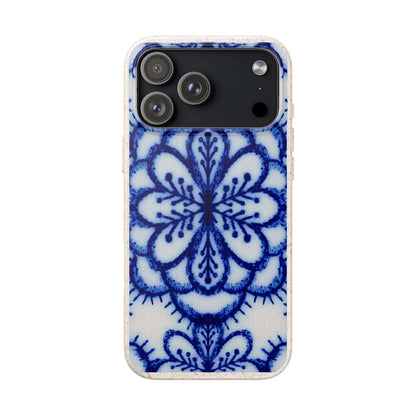 A protective phone case featuring a blue and white floral mandala pattern on a textured white background, shown on a plain white studio background.
