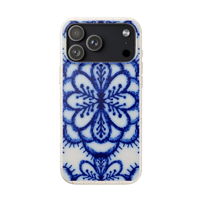 A protective phone case featuring a blue and white floral mandala pattern on a textured white background, shown on a plain white studio background.
