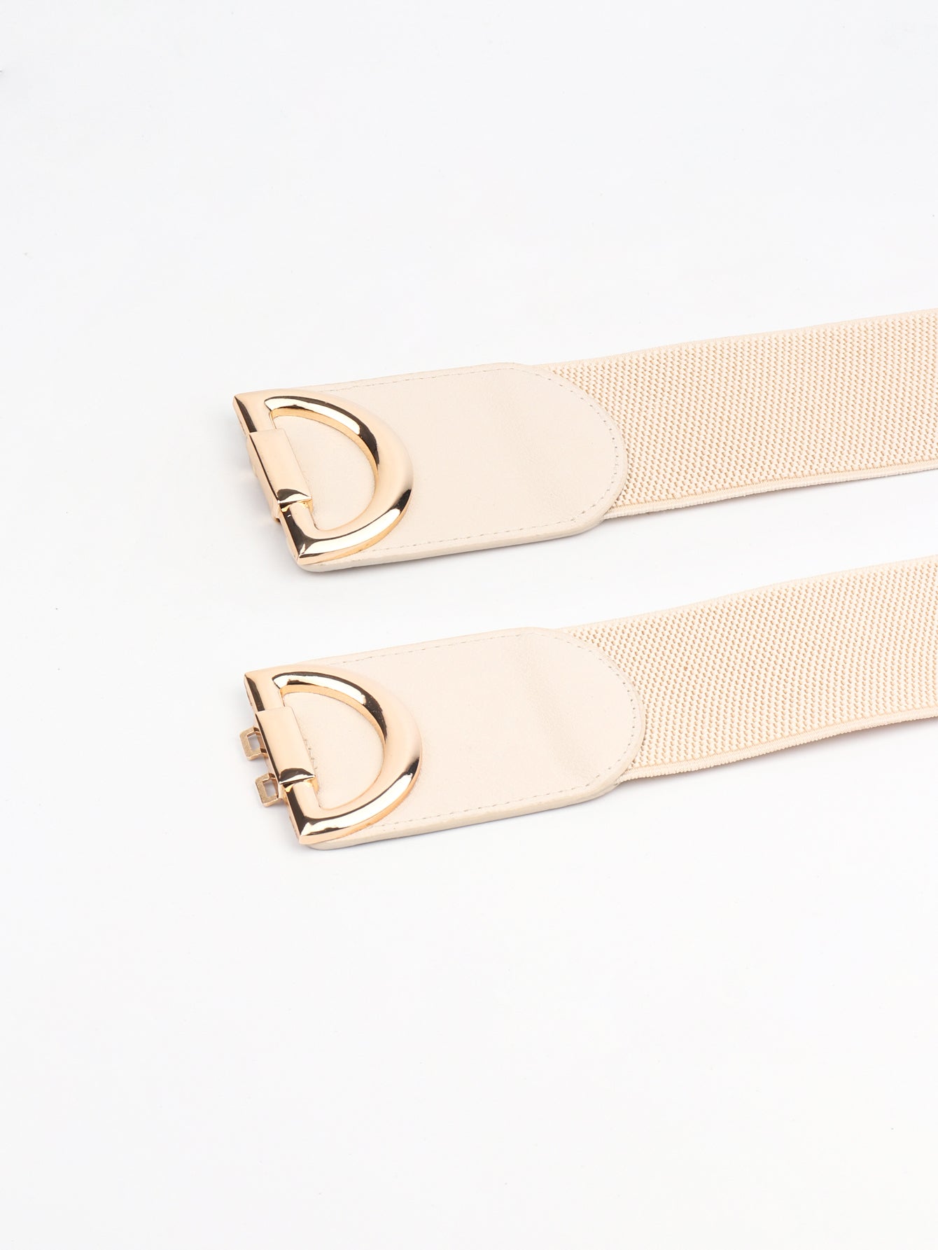Two beige belts with gold buckles on a white background