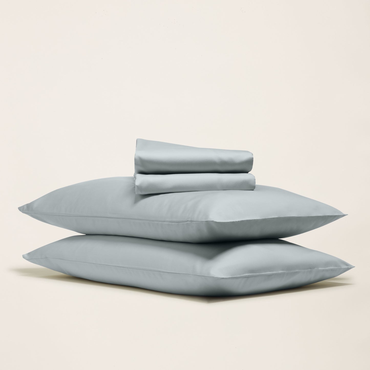 Set of light blue pillows on a beige background