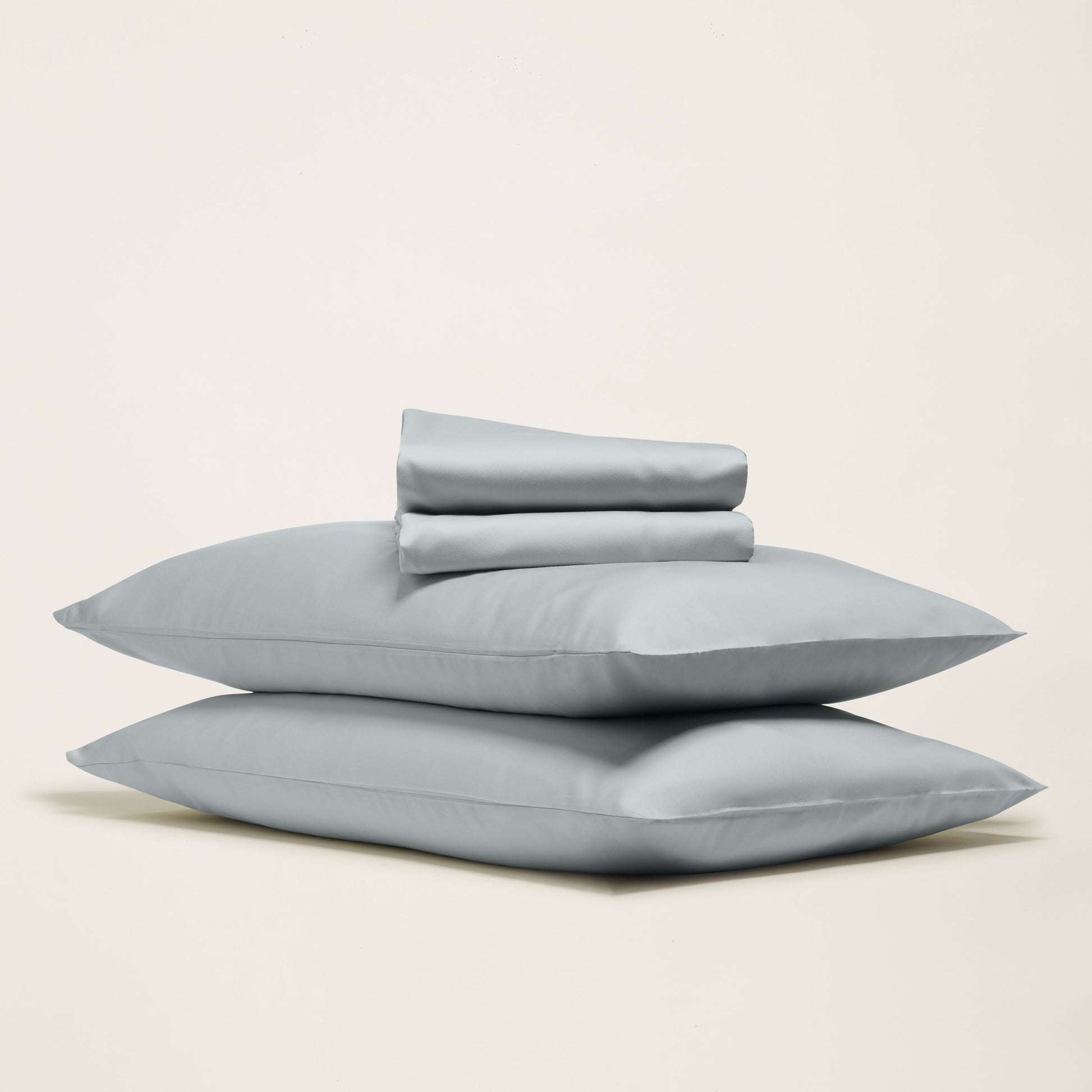 Set of light blue pillows on a beige background
