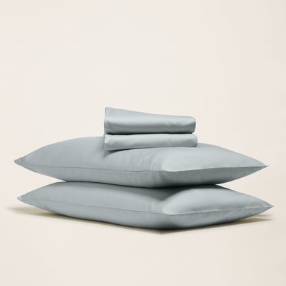 Set of light blue pillows on a beige background