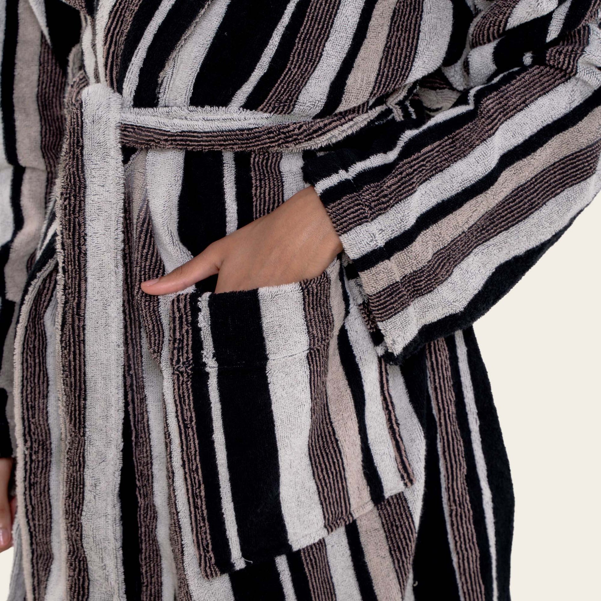 Striped robe with a hand in the pocket on a white background