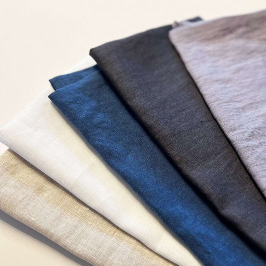 Five different fabric swatches in various colors on a light background