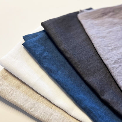 Five different fabric swatches in various colors on a light background