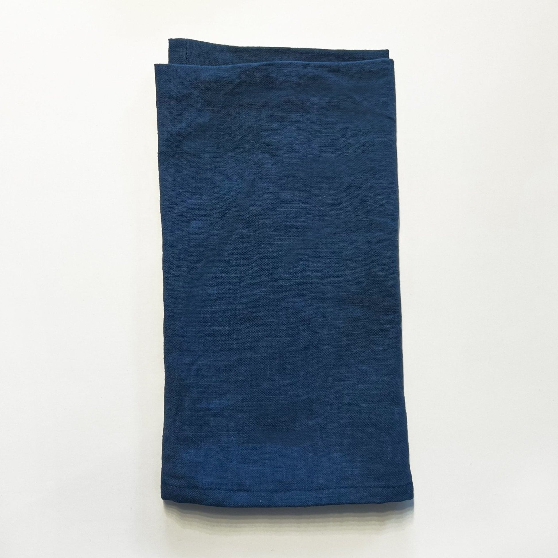 Folded blue towel on a white background