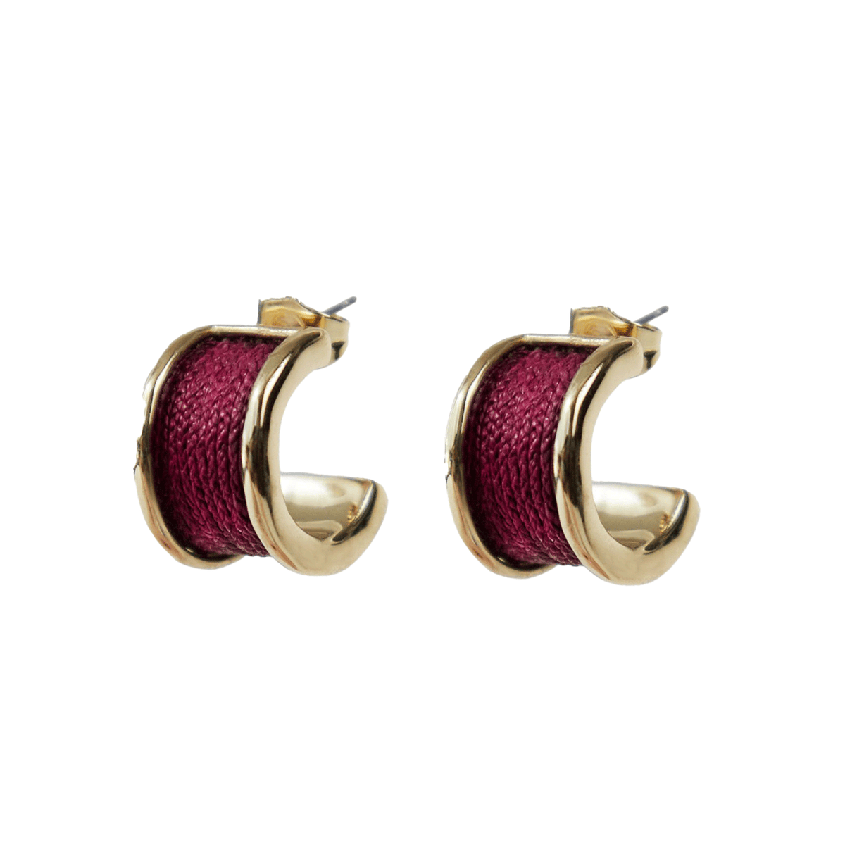 Gold hoop earrings with red fabric center on a white background