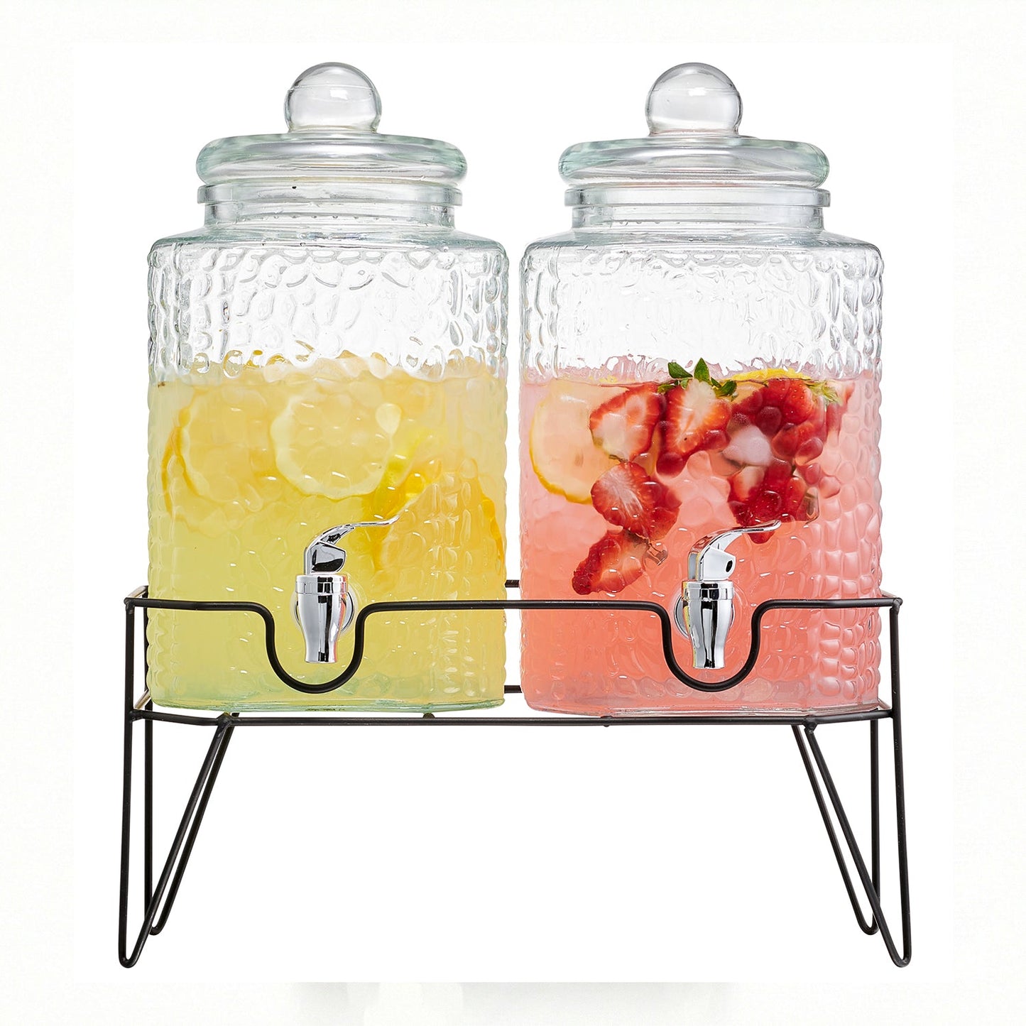 Two textured glass beverage dispensers with metal spigots on a black wire stand, filled with lemon and strawberry drinks.