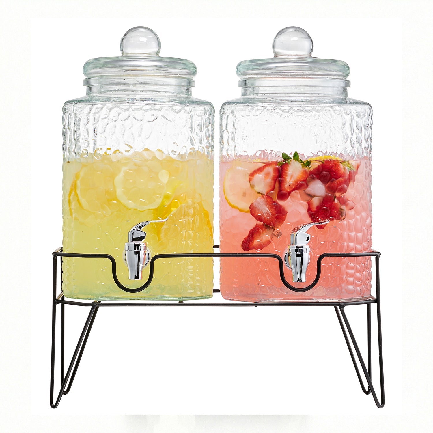 Two textured glass beverage dispensers with metal spigots on a black wire stand, filled with lemon and strawberry drinks.