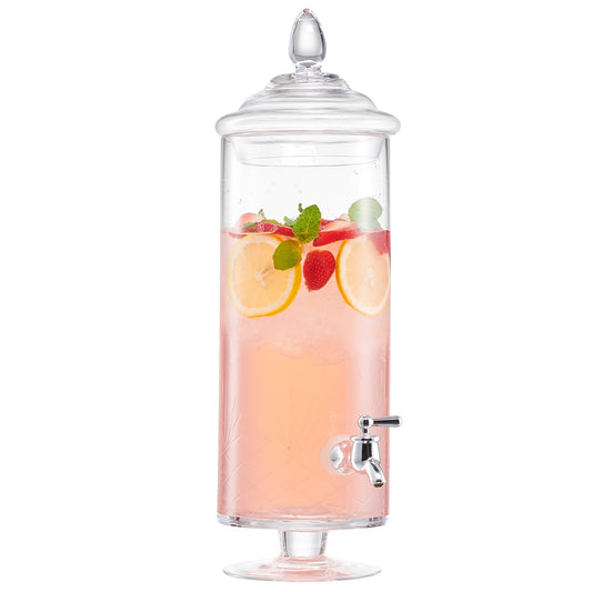 Tall glass beverage dispenser with a metal spigot, filled with pink liquid, lemon slices, and strawberries.
