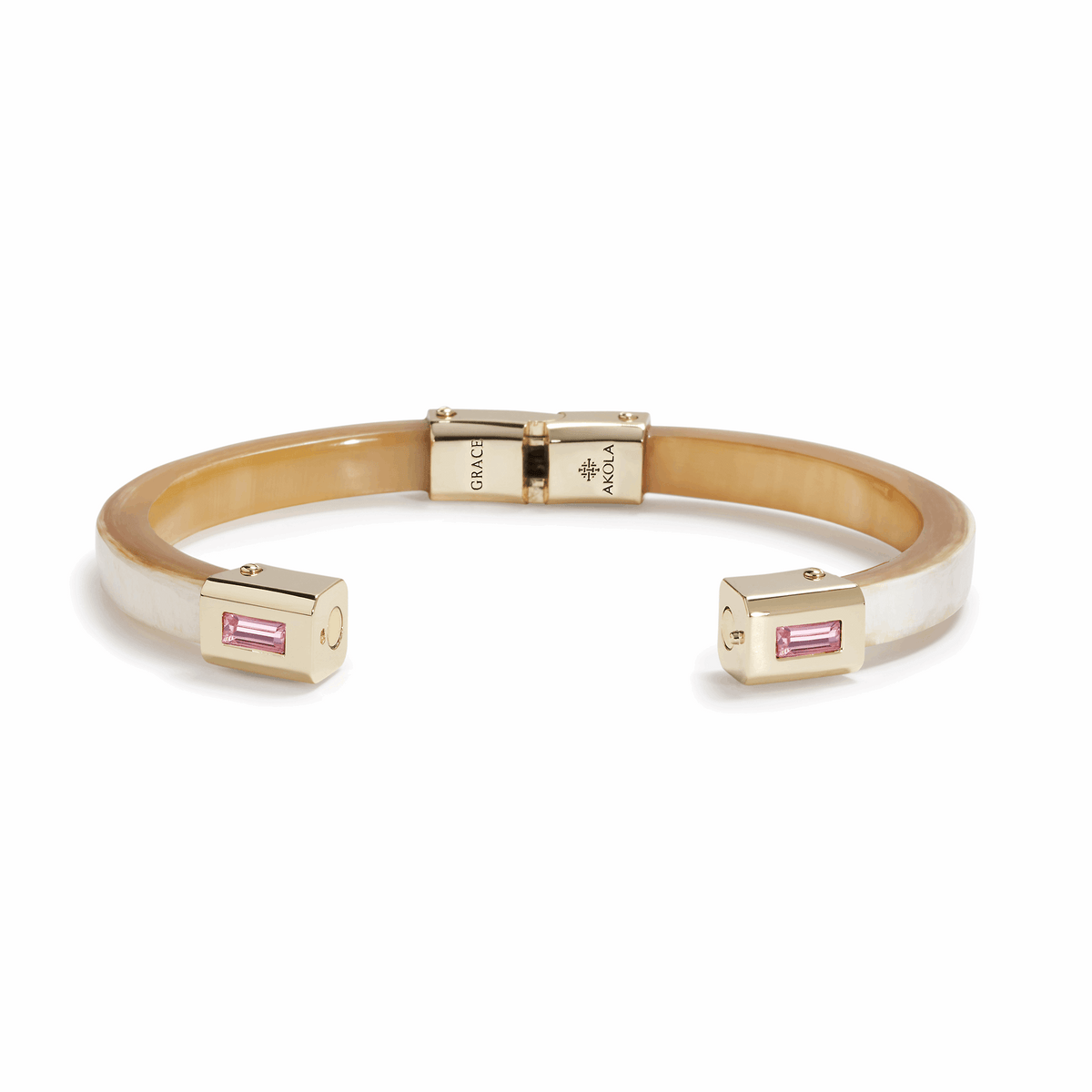 Bracelet with gold clasp and pink gemstones on a white background