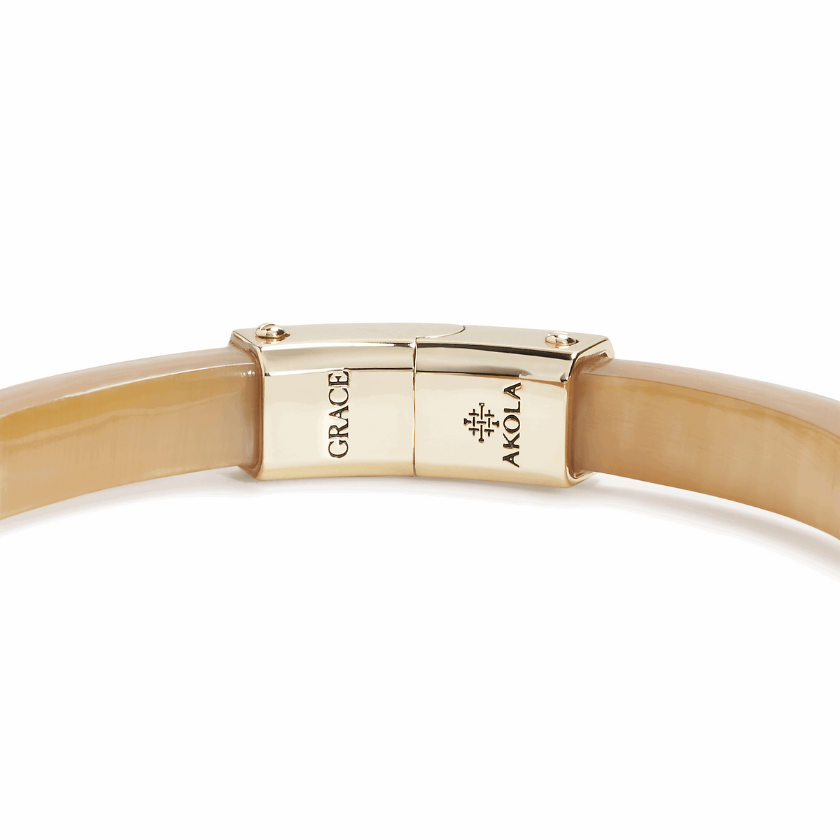 Gold bracelet with 'Grace' and 'Akola' branding on a white background