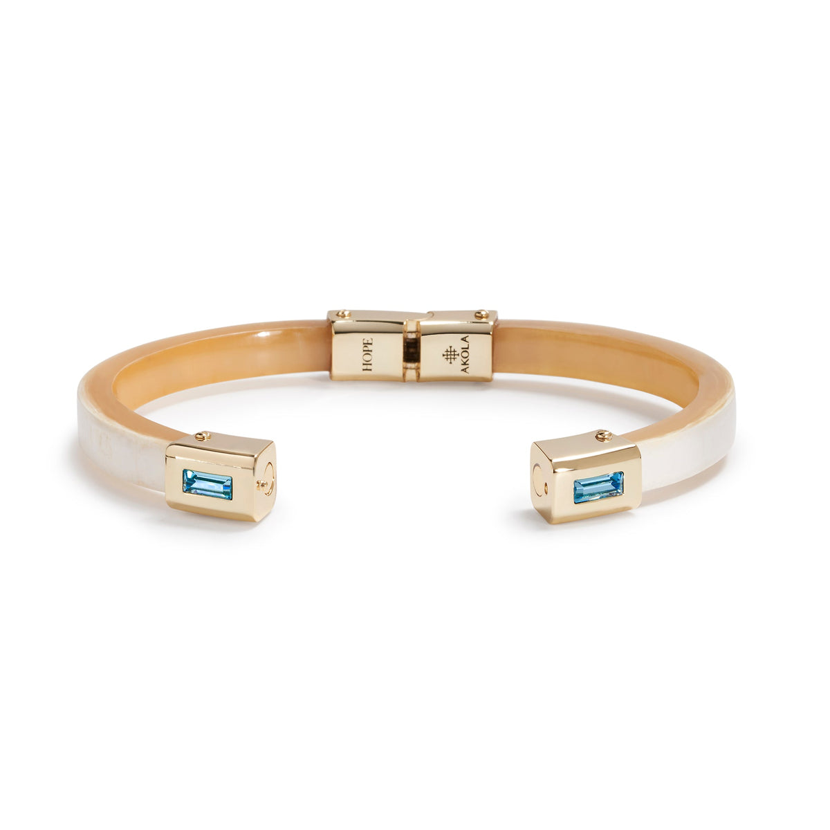 Gold and silver bracelet with blue gemstones on a white background