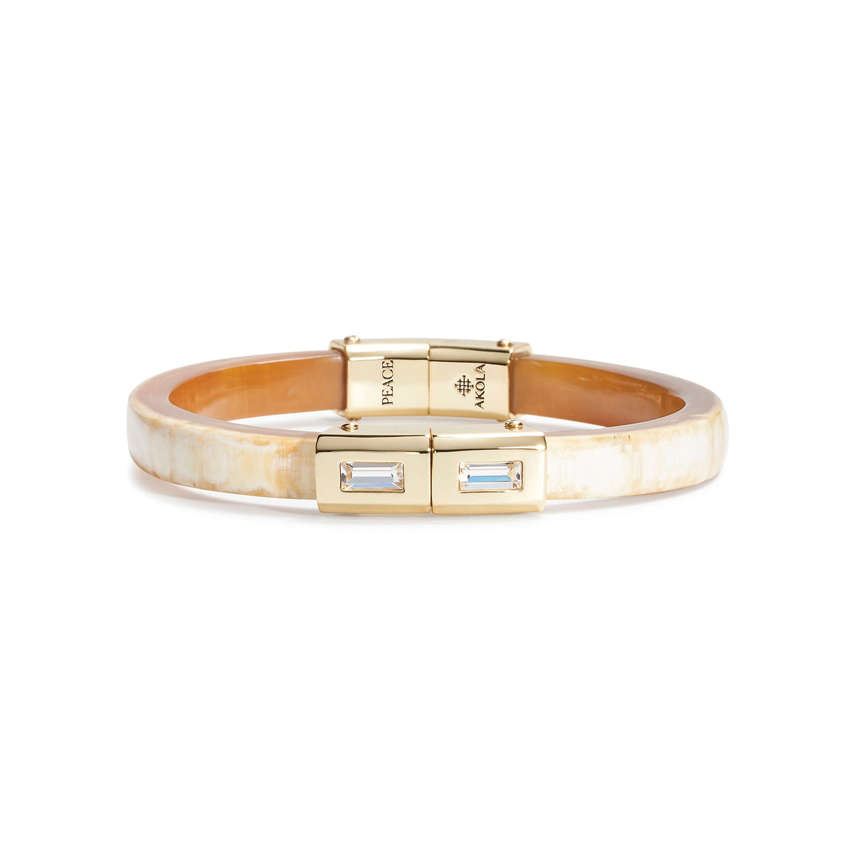 Gold bracelet with a clear gemstone on a white background