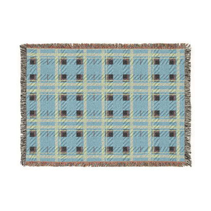 A rectangular woven throw blanket with a light blue plaid pattern, cream and olive green intersecting stripes, and dark brown checkered squares, finished with fringed edges.