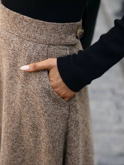 Person wearing a brown skirt with a blurred background