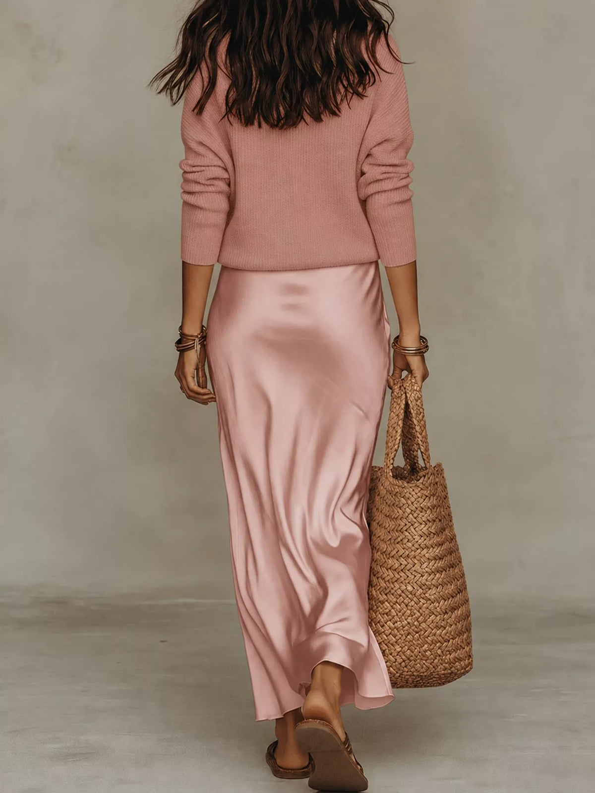 Back view of pink ribbed top and satin midi skirt set.