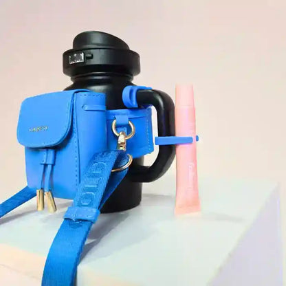 Coldest water bottle in black with a blue mini backpack holder, key hanger, and a pink squeeze holder.