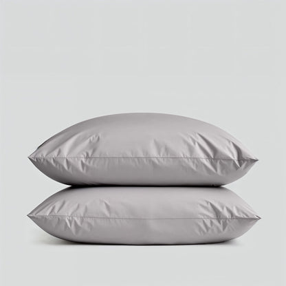 Two gray pillows stacked on a light gray background