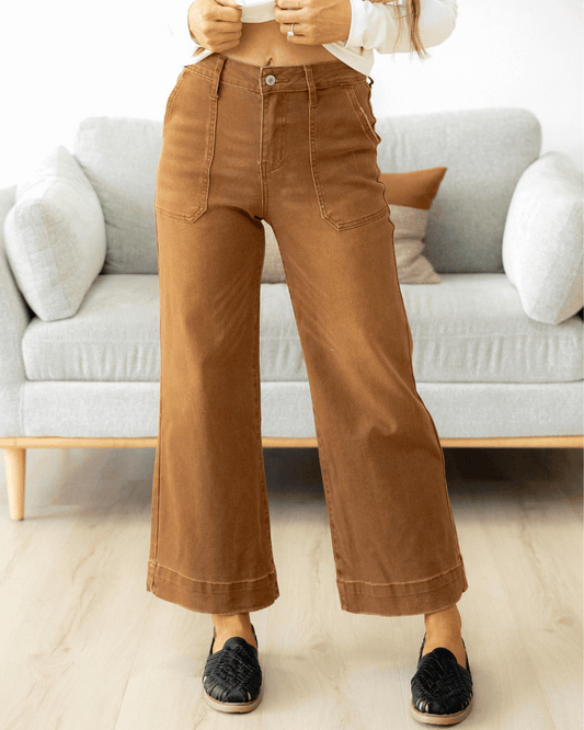 Person wearing brown wide leg cropped jeans.