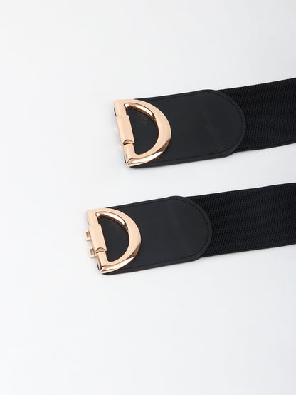 Black belt with rose gold D-ring buckle on a light gray background