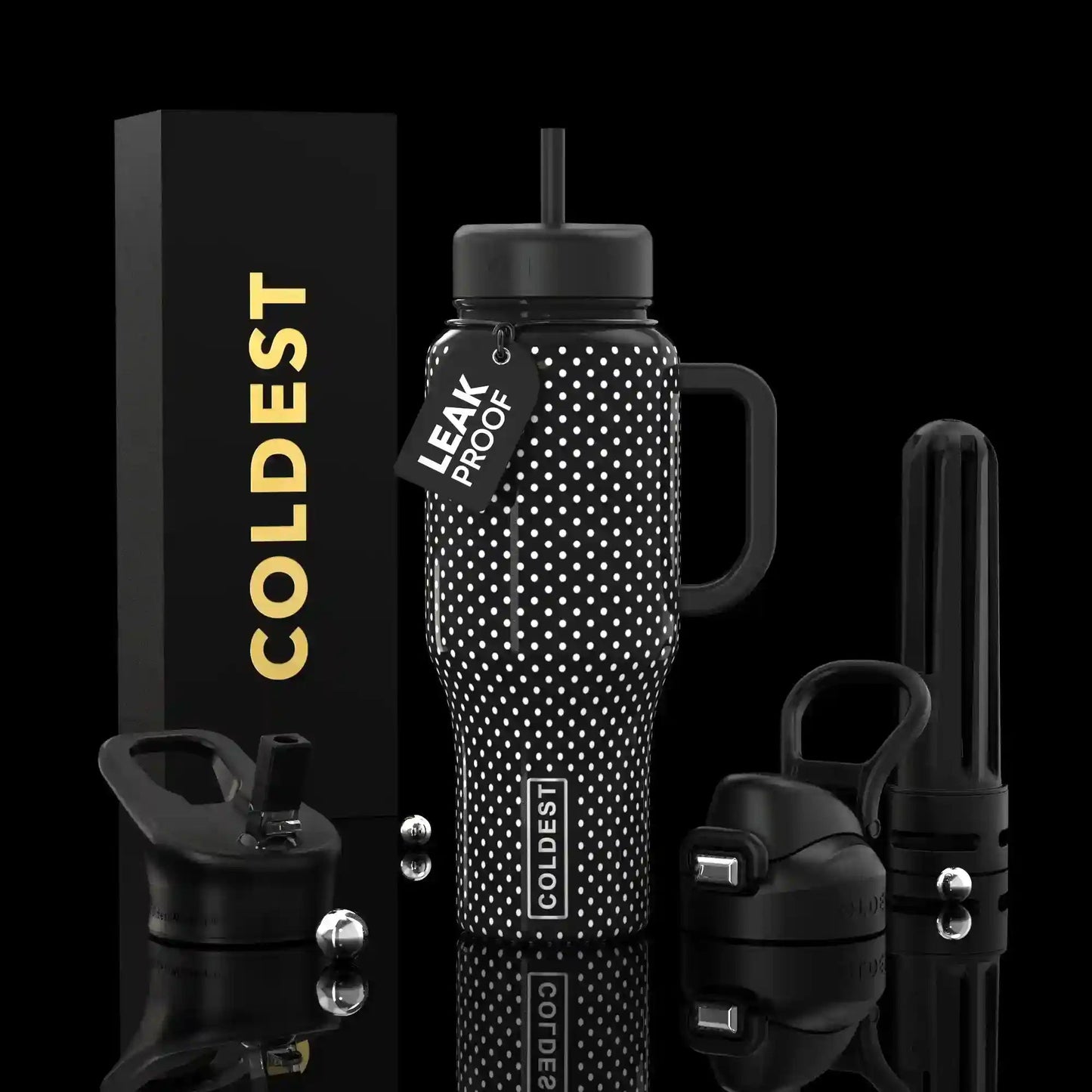 Black water bottle with white polka dots and accessories on a black background
