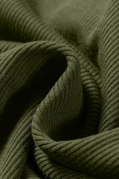 Close-up of ribbed green fabric with a focus on texture.