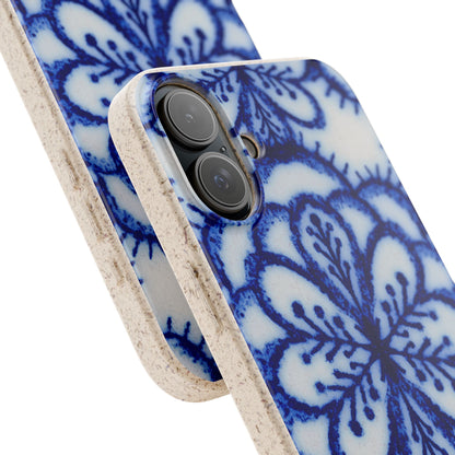 A close-up of a smartphone case with a blue floral mandala pattern on a white background and a natural beige textured edge, shown on a white studio background.