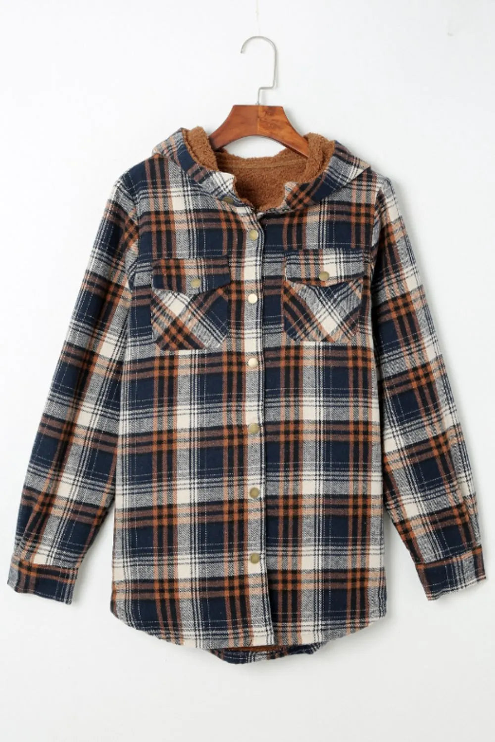 Plaid shirt on a hanger against a white background