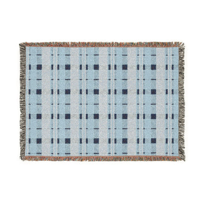 A rectangular woven throw blanket with a light blue and white plaid pattern, dark navy grid lines, and fringed edges on a plain white background.