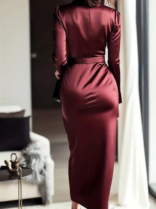 Back View: Back view of satin tie waist dress showing continuous ruched pattern and long sleeve design