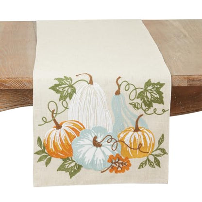 Decorative table runner with pumpkins and leaves on a wooden surface